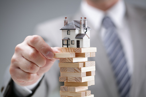 a house model on top of a jinga