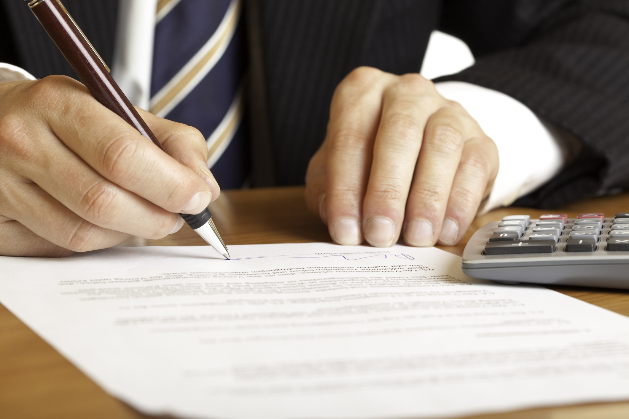 a hands signing a contract